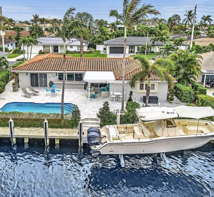 Waterfront Boca Raton home with a boat on a lift