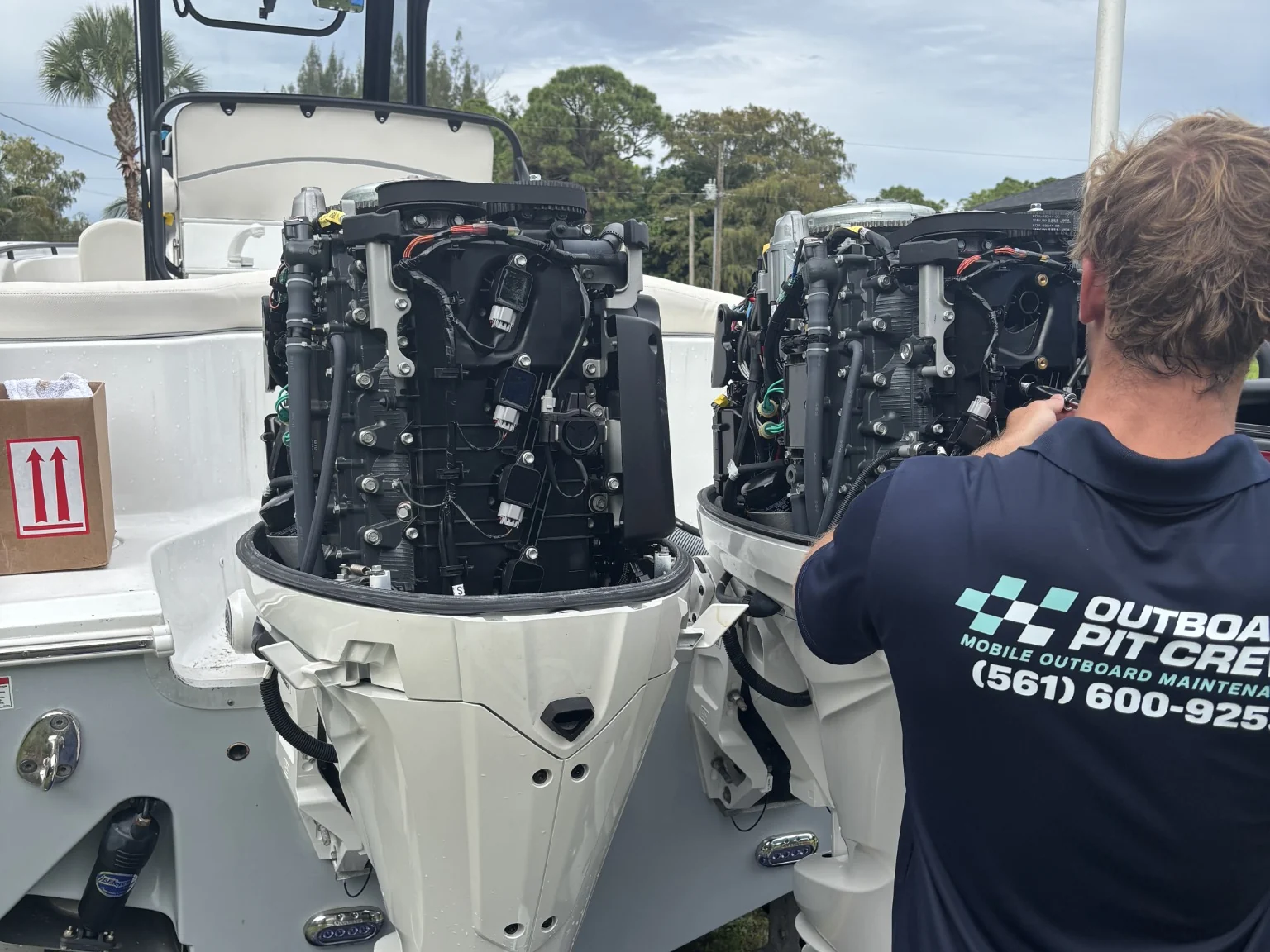 Outboard Pit Crew technician working on twin Yamaha outboards